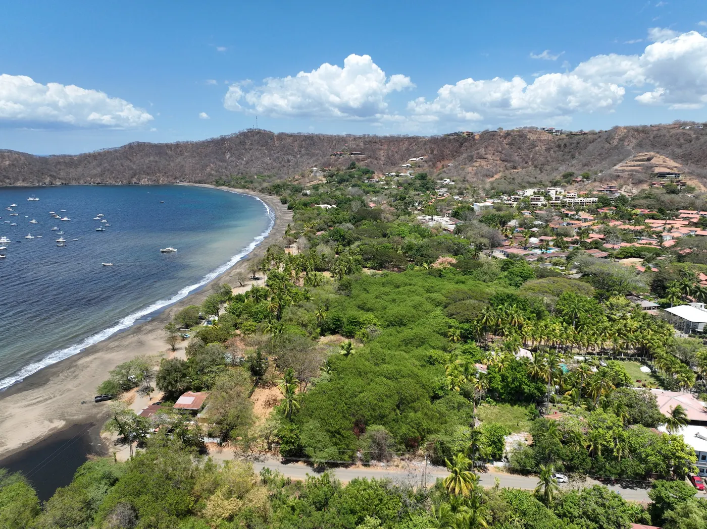 Aerial view of Playas del Coco among the trees beside the bay