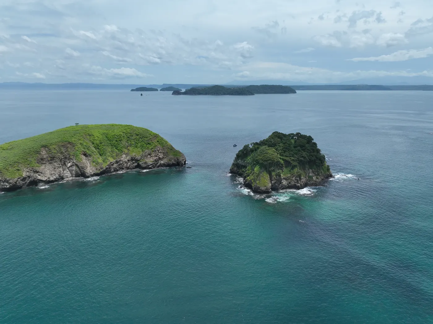 Two small forested islets in turquoise water in Culebra Bay